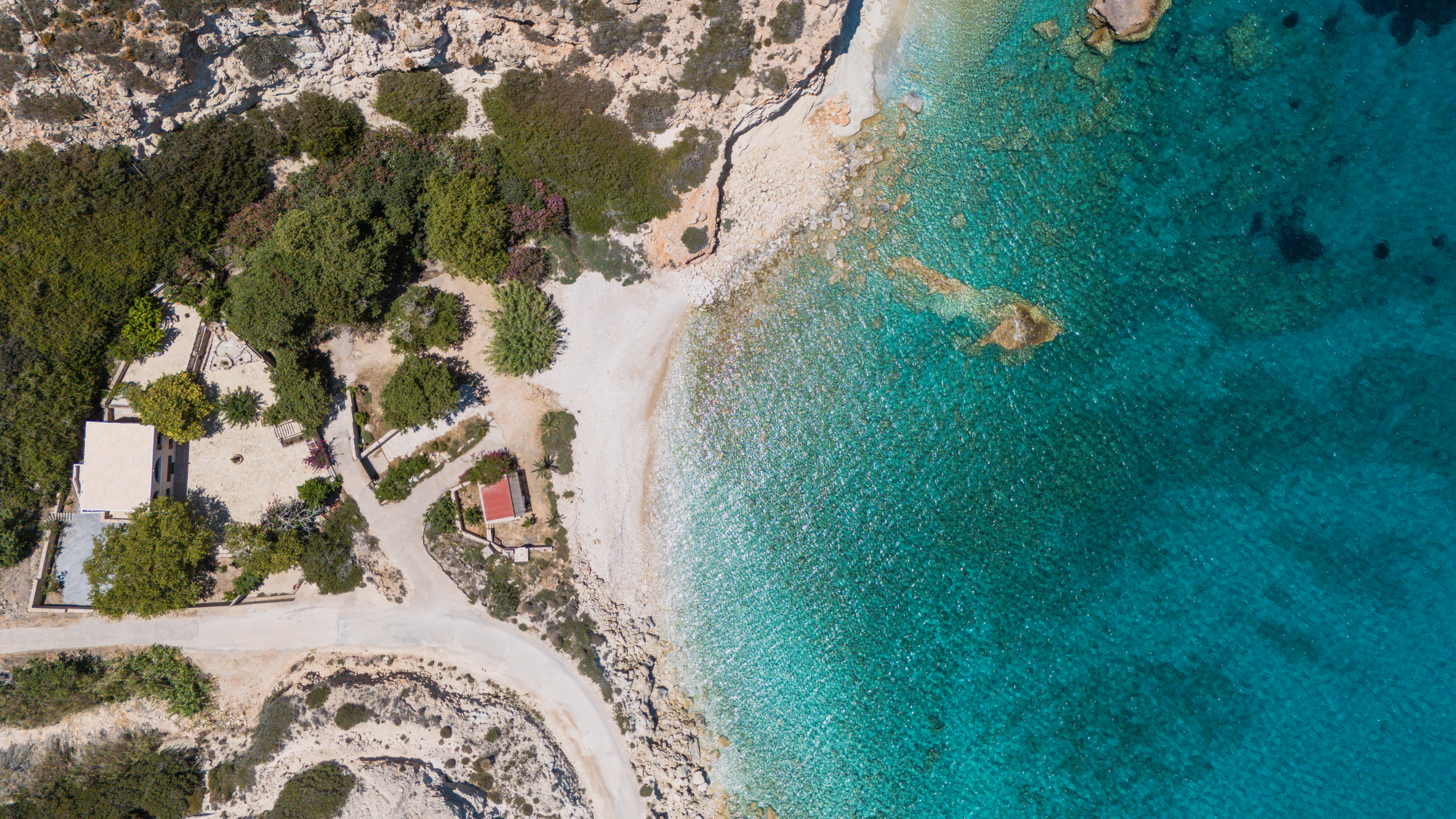 Aerial view of the turquoise bay beside Platani Seaside Villa